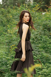 Sleeveless pleated silk dress with high neckline and layered flared hem